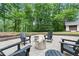 Enjoy the outdoor seating with a fire pit surrounded by the lush greenery of the backyard at 6685 Driskell Rd, Cumming, GA 30041