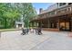 Beautiful backyard with patio, fire pit, and deck overlooking a lush green landscape at 6685 Driskell Rd, Cumming, GA 30041