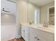 Bright bathroom boasts double sink vanity, a large mirror, and wood-look floors with an attached carpeted bedroom at 6685 Driskell Rd, Cumming, GA 30041