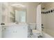 Well-lit bathroom featuring a vanity, mirror, shelves, bathtub, toilet, and shower with a curtain at 6685 Driskell Rd, Cumming, GA 30041