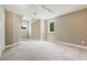 Spacious carpeted bedroom features neutral walls, recessed lighting, and large windows providing natural light at 6685 Driskell Rd, Cumming, GA 30041