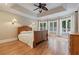 Spacious bedroom with a tray ceiling, a ceiling fan, and several windows for natural light at 6685 Driskell Rd, Cumming, GA 30041