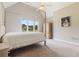 Bedroom with a four-poster bed, ceiling fan, carpeted floor, and a window with an outdoor view at 6685 Driskell Rd, Cumming, GA 30041