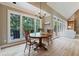 Bright breakfast nook with a view of the back deck and surrounding trees at 6685 Driskell Rd, Cumming, GA 30041