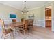Traditional dining room with a large dining table set, light fixture, and hardwood floors, ideal for entertaining at 6685 Driskell Rd, Cumming, GA 30041