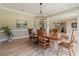 Traditional dining room with hardwood floors, neutral paint, and a chandelier, perfect for Gathering gatherings at 6685 Driskell Rd, Cumming, GA 30041