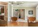Inviting dining room with staircase and view into kitchen with natural light at 6685 Driskell Rd, Cumming, GA 30041