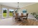 Bright dining room with hardwood floors, a chandelier, and a view of the landscaped yard at 6685 Driskell Rd, Cumming, GA 30041