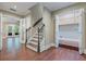 Hallway with hardwood floors, staircase and natural light invites you to this bright and airy home at 6685 Driskell Rd, Cumming, GA 30041