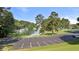 A scenic lake view with lush green trees, a parking lot, and boat docks at 6685 Driskell Rd, Cumming, GA 30041