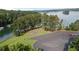 A scenic lake view with lush green trees, a parking lot, and recreational area at 6685 Driskell Rd, Cumming, GA 30041