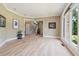 Bright living room featuring hardwood floors and neutral paint with arched windows overlooking exterior landscape at 6685 Driskell Rd, Cumming, GA 30041