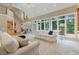 Bright living room with large windows, comfortable seating, and open floor plan at 6685 Driskell Rd, Cumming, GA 30041