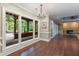 Open-concept living room with fireplace, wood flooring and large windows to the outdoor patio at 6685 Driskell Rd, Cumming, GA 30041