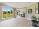 Spacious living room boasts large windows, hardwood floors, and neutral paint, creating an inviting atmosphere at 6685 Driskell Rd, Cumming, GA 30041