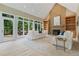 Spacious living room with fireplace, built-in bookshelves, and access to outdoor deck at 6685 Driskell Rd, Cumming, GA 30041