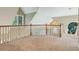 Loft area features wood railing, neutral carpeting and walls, and windows providing natural light at 6685 Driskell Rd, Cumming, GA 30041