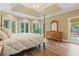 Comfortable main bedroom featuring hardwood floors, a dresser, and access to the outdoor deck at 6685 Driskell Rd, Cumming, GA 30041