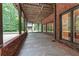 Covered patio with brick accents and recessed lighting, perfect for outdoor entertaining at 6685 Driskell Rd, Cumming, GA 30041