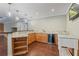 Custom wet bar with wood cabinets, granite counters, wine fridge and bar seating at 6685 Driskell Rd, Cumming, GA 30041