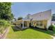 Spacious backyard with a patio, lush greenery, and well-maintained lawn at 964 Natural Brook Trl, Lawrenceville, GA 30045