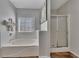 Bathroom featuring a soaking tub and separate glass-enclosed shower at 964 Natural Brook Trl, Lawrenceville, GA 30045