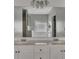 Bathroom featuring a double sink vanity and an extra-large mirror at 964 Natural Brook Trl, Lawrenceville, GA 30045
