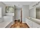 Bright bathroom with a soaking tub, double vanity, and separate shower at 964 Natural Brook Trl, Lawrenceville, GA 30045