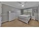Cozy bedroom with a ceiling fan, white furniture, and soft gray walls at 964 Natural Brook Trl, Lawrenceville, GA 30045