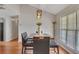 Cozy dining space with a modern light fixture and a view of the outdoors through a bright window at 964 Natural Brook Trl, Lawrenceville, GA 30045