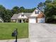 Charming traditional home featuring a two-car garage and well-manicured front lawn at 964 Natural Brook Trl, Lawrenceville, GA 30045