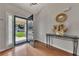 Bright foyer with hardwood floors, an open door, and a decorative table creating an inviting entrance at 964 Natural Brook Trl, Lawrenceville, GA 30045
