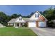 Charming home with a well-manicured lawn, brick accents, and a two-car garage, perfect for suburban living at 964 Natural Brook Trl, Lawrenceville, GA 30045
