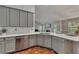 Well-equipped kitchen with gray cabinetry, quartz countertops, and stainless steel appliances at 964 Natural Brook Trl, Lawrenceville, GA 30045