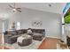 Spacious living room featuring a vaulted ceiling, gray sofa, and hardwood floors at 964 Natural Brook Trl, Lawrenceville, GA 30045
