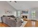 Comfortable living room with a large sectional sofa, fireplace, and hardwood flooring at 964 Natural Brook Trl, Lawrenceville, GA 30045