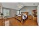 Spacious main bedroom featuring hardwood floors, a vaulted ceiling, and a large window at 964 Natural Brook Trl, Lawrenceville, GA 30045
