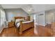 Bright main bedroom with hardwood floors, a vaulted ceiling, and ensuite bathroom access at 964 Natural Brook Trl, Lawrenceville, GA 30045