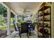 Covered patio with outdoor seating, ceiling fan, and view of landscaped backyard at 964 Natural Brook Trl, Lawrenceville, GA 30045