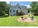 Backyard with well-maintained lawn, fire pit, deck and house at 20 Scarlett Oak Ne Dr, Cartersville, GA 30121