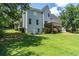 View of the home's spacious backyard, featuring a wooden deck, green lawn, and mature trees at 20 Scarlett Oak Ne Dr, Cartersville, GA 30121