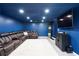 Basement with blue walls, large sectional sofa, tv, concrete floor, and recessed lighting at 20 Scarlett Oak Ne Dr, Cartersville, GA 30121