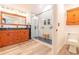 Bathroom featuring walk-in shower with glass doors, wood floor and cabinets at 20 Scarlett Oak Ne Dr, Cartersville, GA 30121