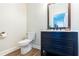 Stylish half bathroom with blue vanity and marble countertop at 20 Scarlett Oak Ne Dr, Cartersville, GA 30121