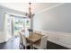 Elegant dining room with large windows, wood table, and chandelier at 20 Scarlett Oak Ne Dr, Cartersville, GA 30121