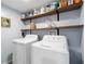 Laundry room with grey walls, shelving and white washer and dryer at 20 Scarlett Oak Ne Dr, Cartersville, GA 30121