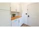 Mudroom with white cabinets, butcher block countertop, and tile floor at 20 Scarlett Oak Ne Dr, Cartersville, GA 30121