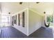Cozy covered porch with a hanging hammock chair and dark wood flooring, great for relaxing at 20 Scarlett Oak Ne Dr, Cartersville, GA 30121