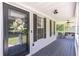 Inviting covered front porch featuring a dark wood floor, ceiling fans, and charming decor at 20 Scarlett Oak Ne Dr, Cartersville, GA 30121