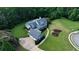 Large private lot featuring a home with a detached garage, long driveway, and landscaping, all backing to woods at 200 Chaparral Trce, Tyrone, GA 30290